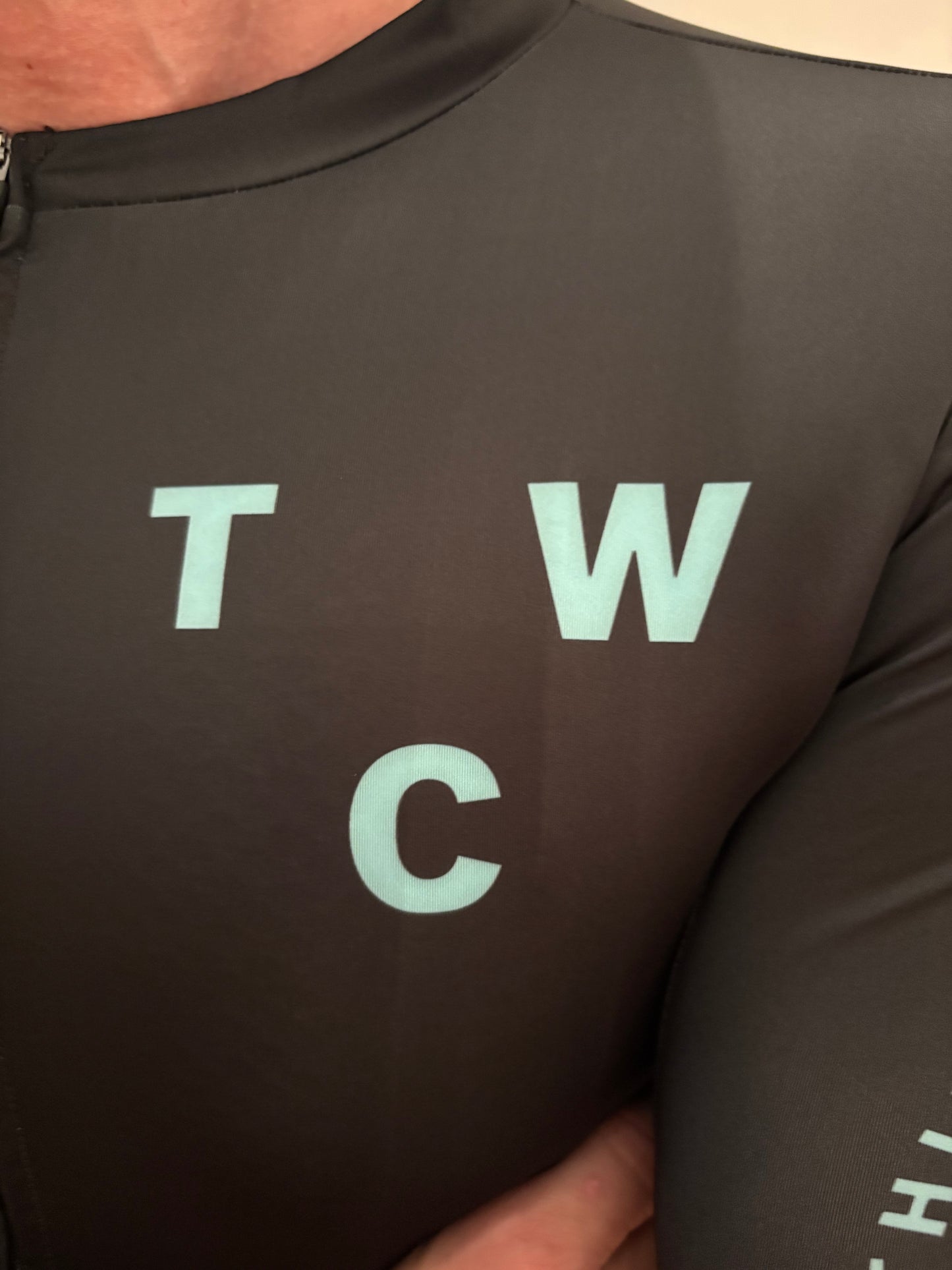 Black Jersey top with light blue text on a person wearing it.