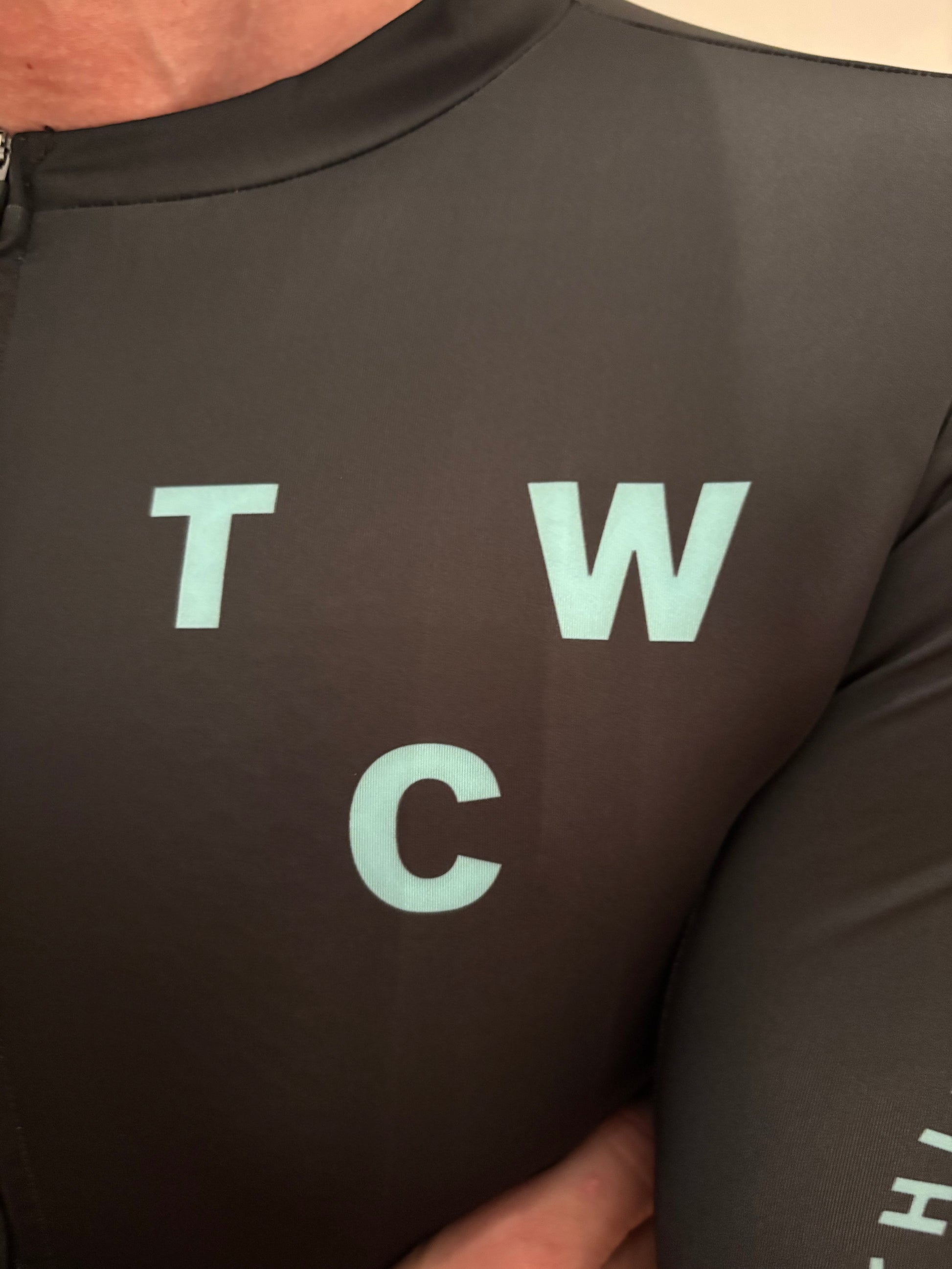 Black Jersey top with light blue text on a person wearing it.